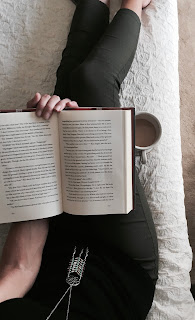 Taking a day off A person sitting down with a book and coffee