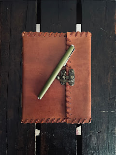 Journal and pen A journal with a pen