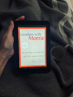 Tuesdays with Morrie Hand holding a book