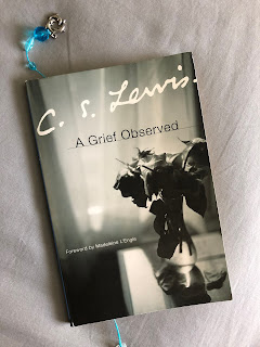 A Grief Observed A book, A Grief Observed, laying on a table.